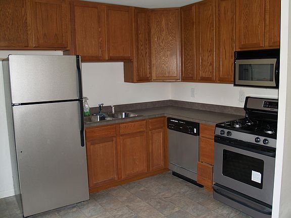 Kitchen has dishwasher, gas stove, built in microwave and refrigerator. Cabinets go to ceiling.