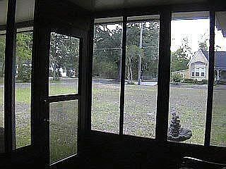 Small sunroom / foyer with view of historical homes.