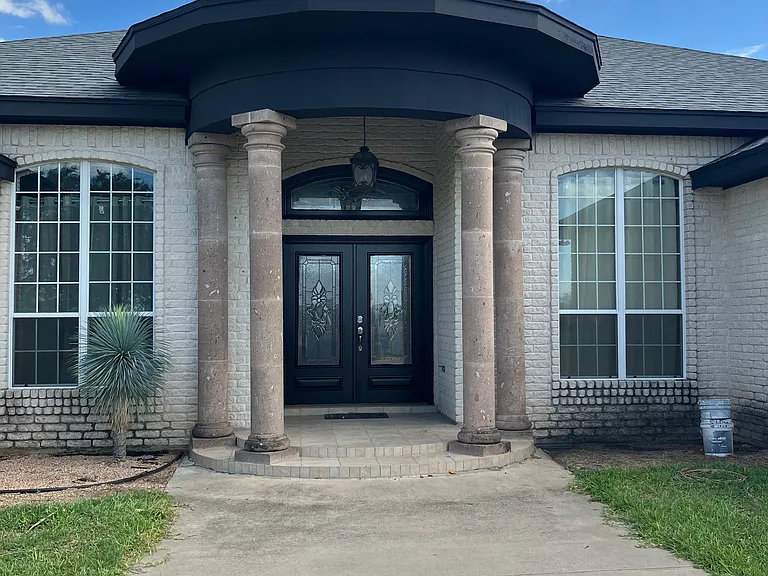 Large private driveway with gated access and plenty of parking _ includes both garage and additional space for guests or work vehicles.