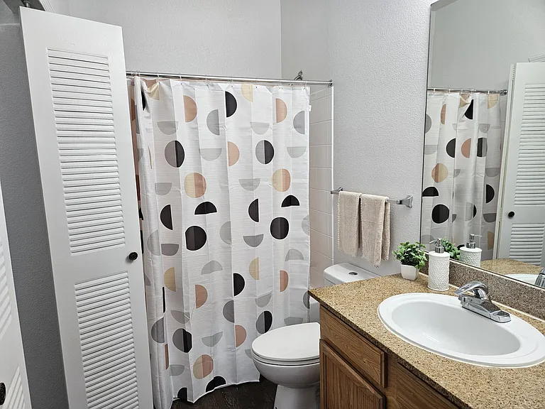 Modern and clean bathroom featuring quality fixtures, a spacious shower, and ample lighting_designed for comfort and convenience.