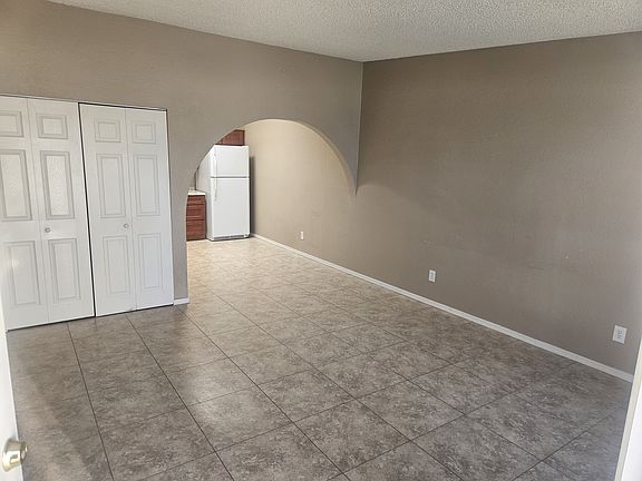 Main living room area looking towards the kitchen.