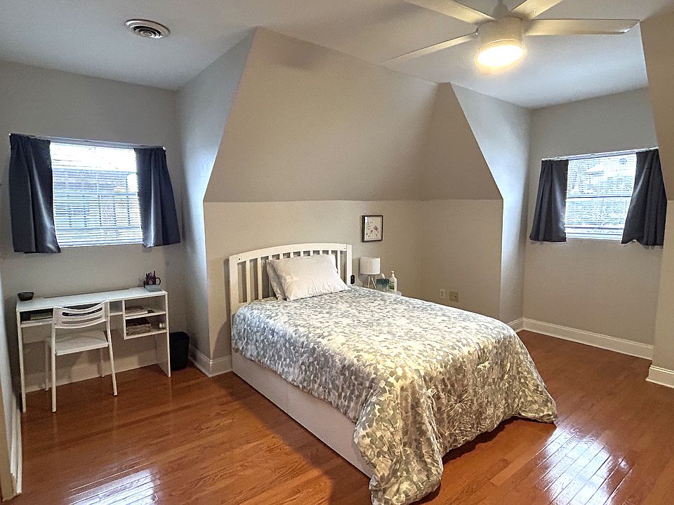 Spacious bedroom fits desk nicely near natural lighting
