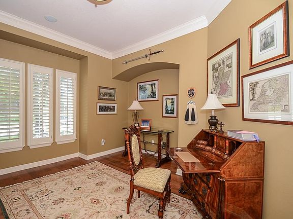 Study with gorgeous hardwoods and plantation shutters.