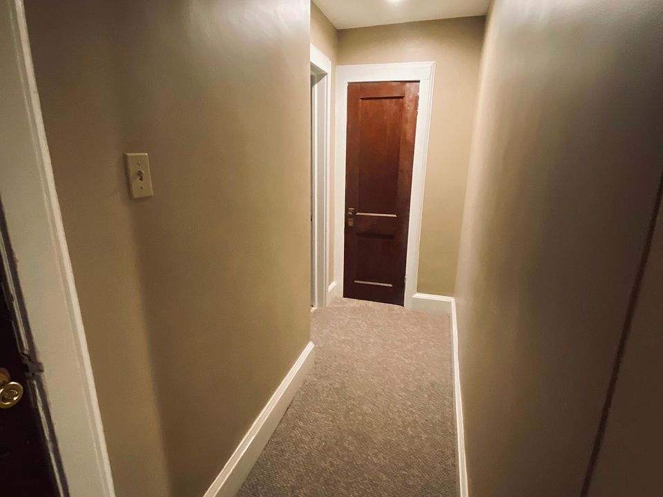 Hallway to Living Room with Coat Closet at end of hall.