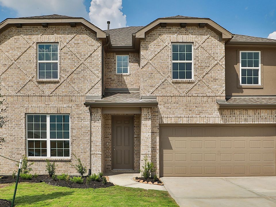 Elegant brick facade and expansive windows define this Creekhaven estate, blending luxury with natur