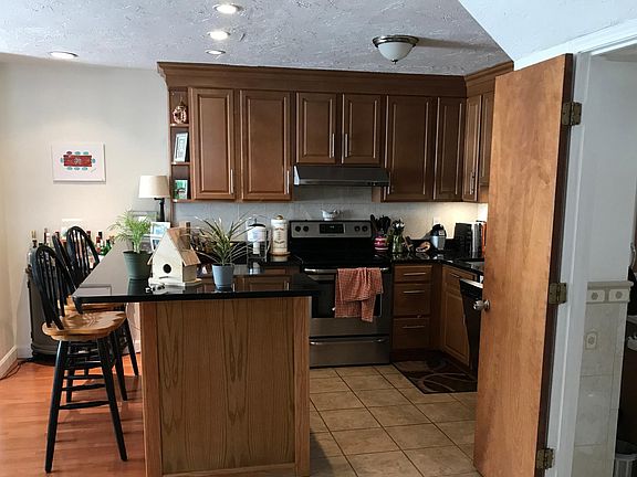 renovated kitchen, with stainless steel appliances, granite counters, plenty of cupboards and a breakfast bar. Half bath off to the side.