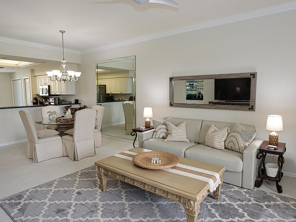 Spacious living area w/queen sleeper sofa, large TV, and small built-in bar ... This area can be expanded into the enclosed back lanai by opening the sliding stacker doors.