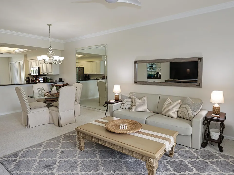 Spacious living area w/queen sleeper sofa, large TV, and small built-in bar ... This area can be expanded into the enclosed back lanai by opening the sliding stacker doors.