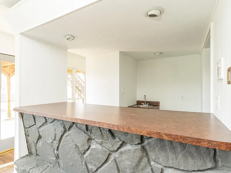 Wet bar area with fridge connection and sink. Washer/dryer connection in adjacent room