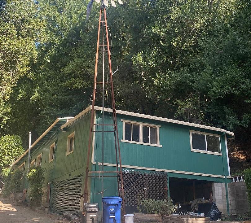 Front of home with an original windmill