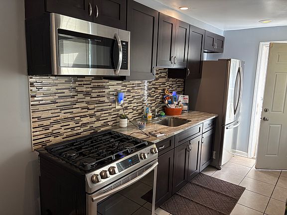 Kitchen with new Stove, Fridge and Microwave