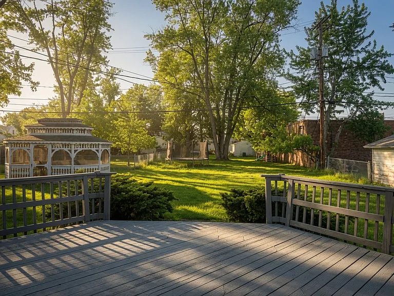Private backyard oasis viewed from the expansive deck _ complete with screened gazebo and plenty of green space.
