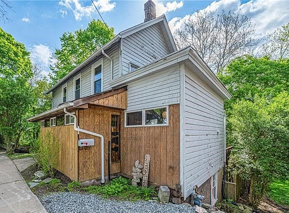 Looks can be deceiving! A fresh coat on the hardwood siding and stain on the fence...