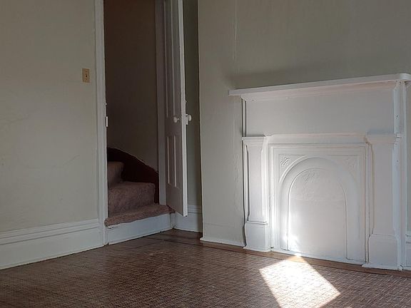 Second floor bedroom with stairway to attic