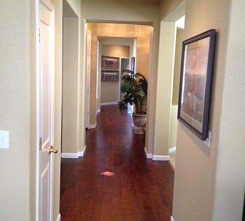 Hallway from entry to 3 bedrooms, a full bath and half bath