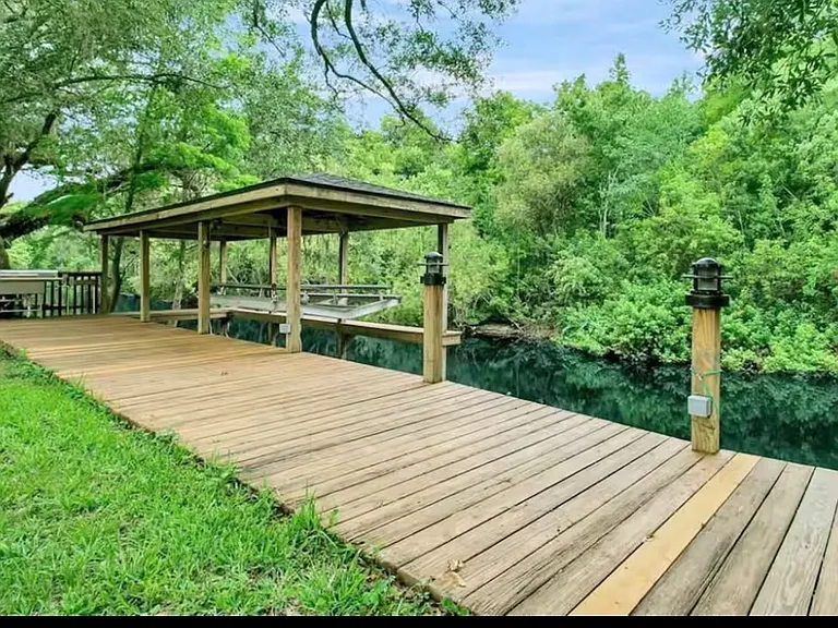 Long dock and boathouse in backyard
