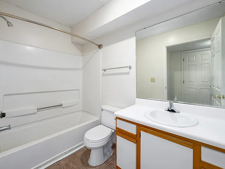 Clean, bright bathrooms feature toilet, sink, and full bathtub for comfortable living, professionally operated by Highlands Vista Group.