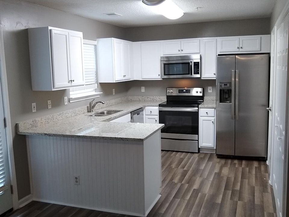 Kitchen, breakfast bar, pantry, wood cabinets, marble countertops, stainless steel appliances. Laundry area.