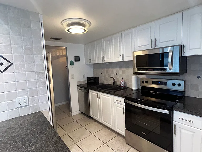 View of microwave and new range in kitchen