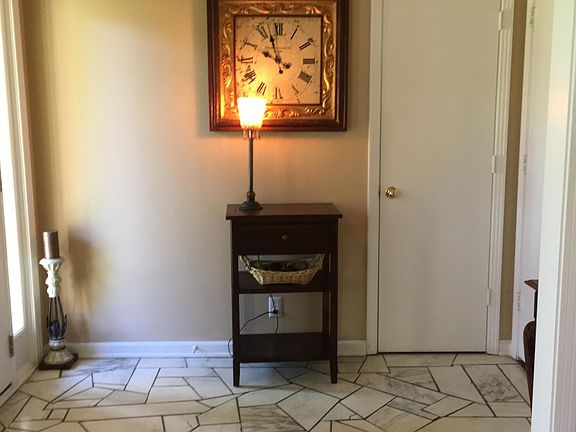 Foyer with marble tile and closet