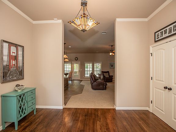 View from Foyer into Family Room reveals neutral paint palette and elegant crown moulding.