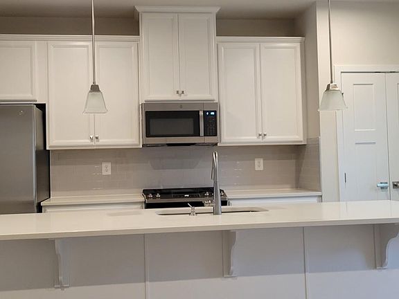 Open kitchen with stainless steel appliance and a very function island with spacious seating