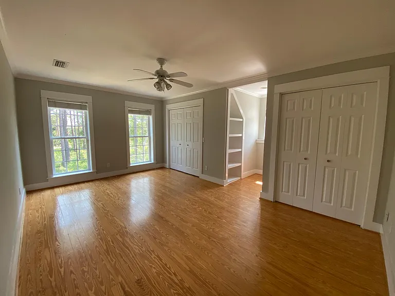 Upstairs bedroom #1. Two closets, book shelves, reading nook, floor to ceiling windows.
