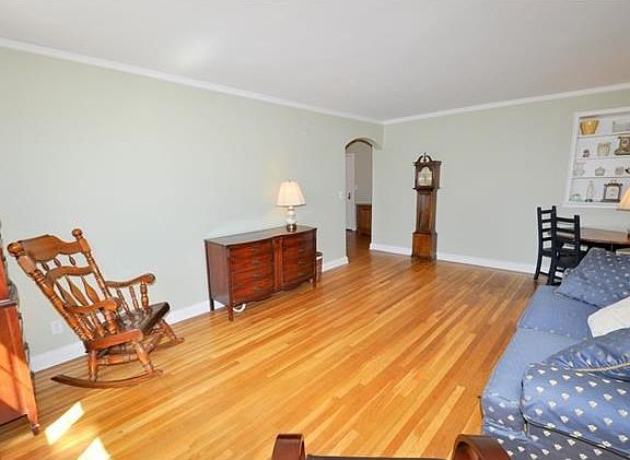 The large bright and airy living area has sunny Southern exposures, built-in bookcase and refinished hardwood floors.  The room is 20'-4" x 13'-0".
