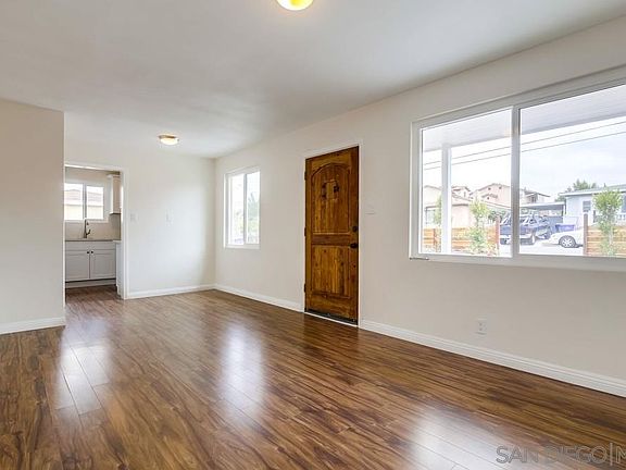 Entrance/main room (living area). Street-facing window view. Kitchen to the right as you enter through the front door.