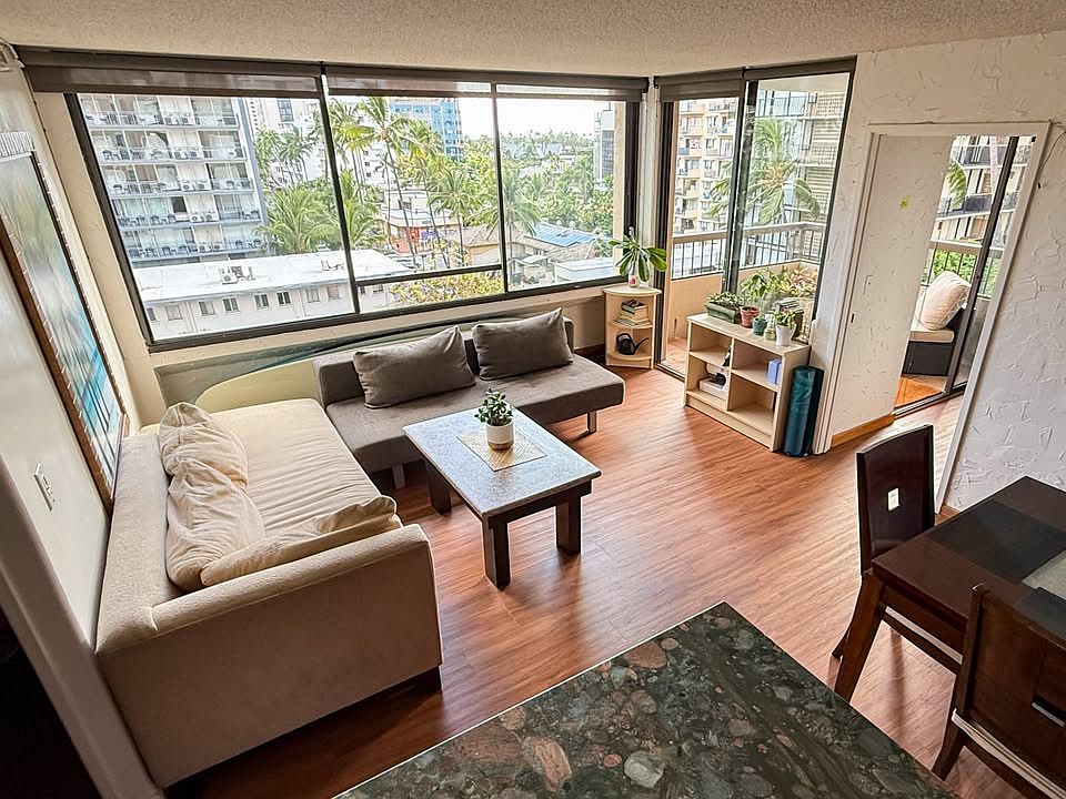 Comfortable shared living space with lots of light. We have recently replaced this sofa with a newer sectional.