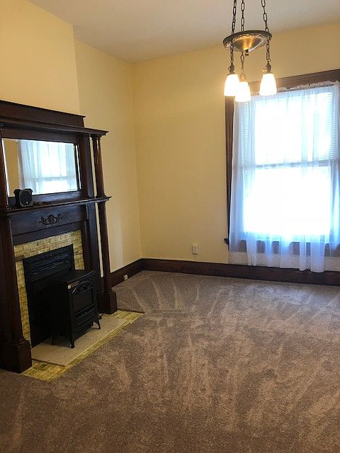 Parlor, first floor, original non working fireplace and mantel, has working pocket doors.