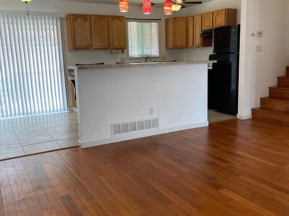 View from the front door: Living room, breakfast bar, kitchen, and sliding glass door to the back yard.