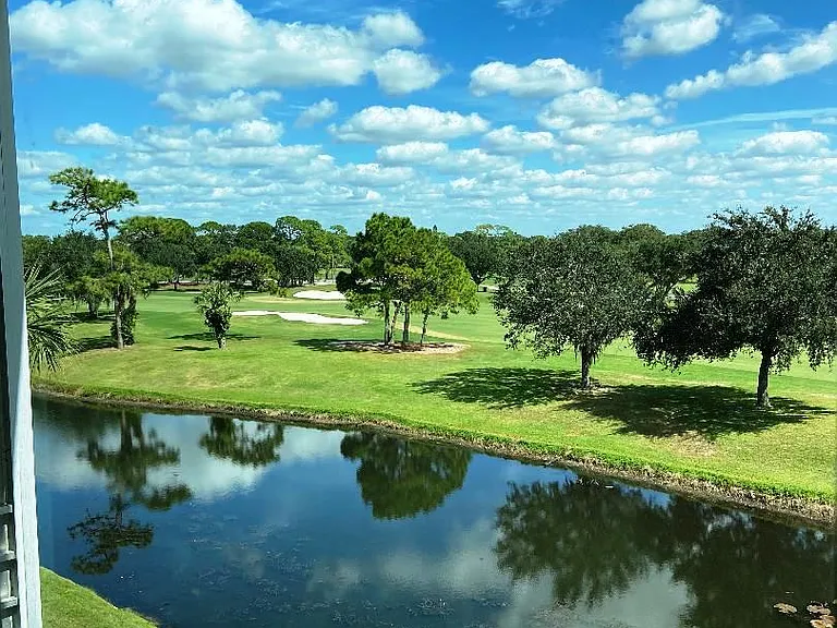 View from den/guest bedroom over Palm Aire Champions golf course and beyond.