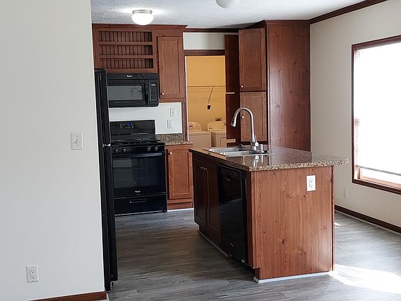 LVP throughout kitchen. Island with sink, upgraded faucet, garbage disposal and dishwasher