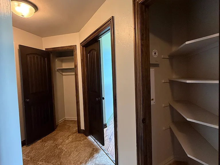 Three bedrooms sit on the east side of the house. There are two closets in the hallway. One coat closet and the other one is for linens. This house has lots of storage options.