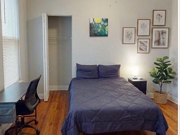 Ceiling fan workspace with an adjustable office chair and easy access closet.