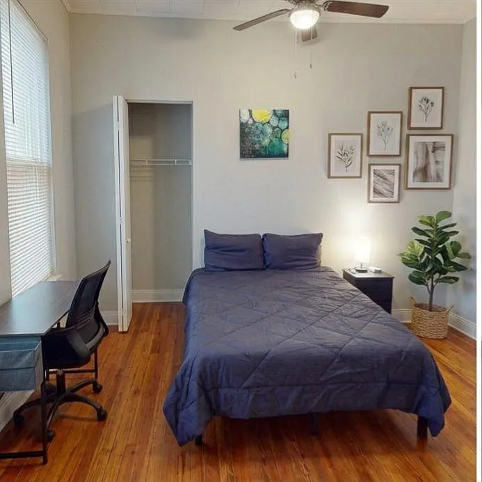 Ceiling fan workspace with an adjustable office chair and easy access closet. - Arunah Ave