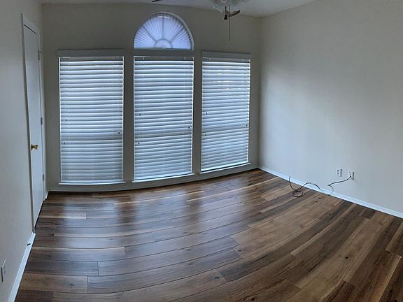 Bedroom with large windows for fresh air and lots of sunlight.
