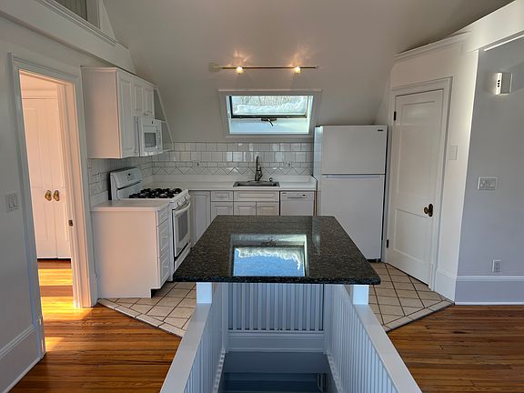 Kitchen. Bedroom door to left. Living/family room to right