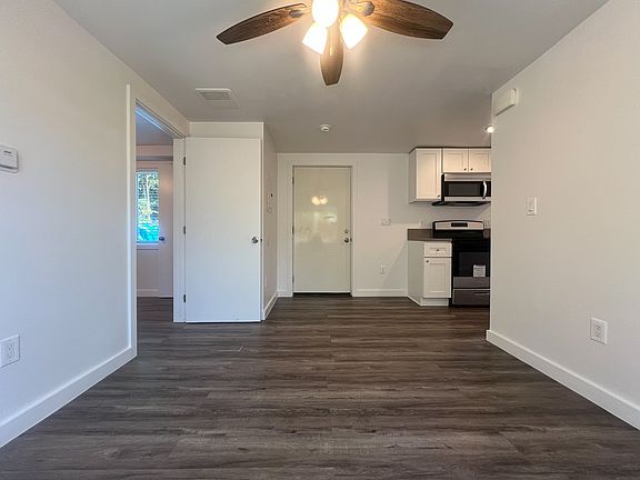 View of the living room when facing the front door. The second bedroom is on the left hand side, the kitchen is on the right hand side.