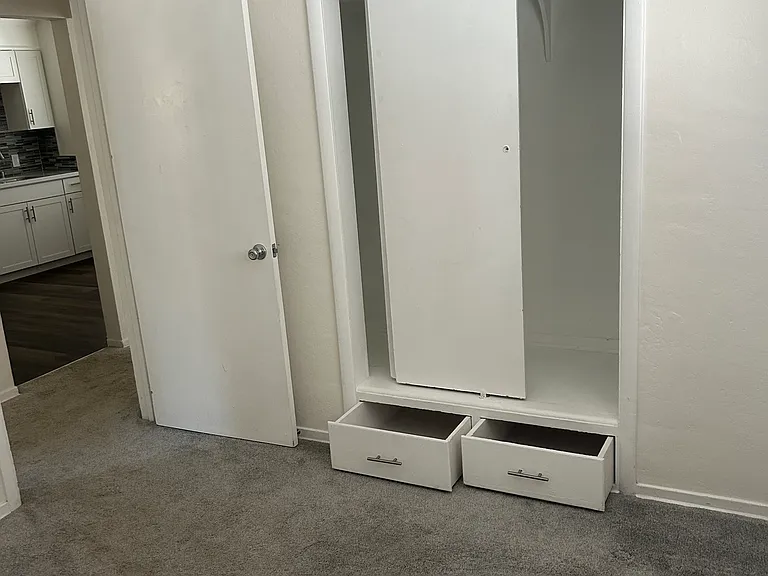 The closet and built-in storage for bedroom #2. Also, to the left is the door leading to the hallway.