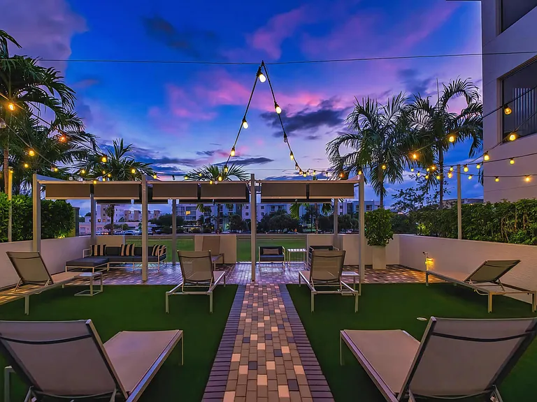Modern Outdoor Patio with Lounge Seating and String Lights at South of Atlantic