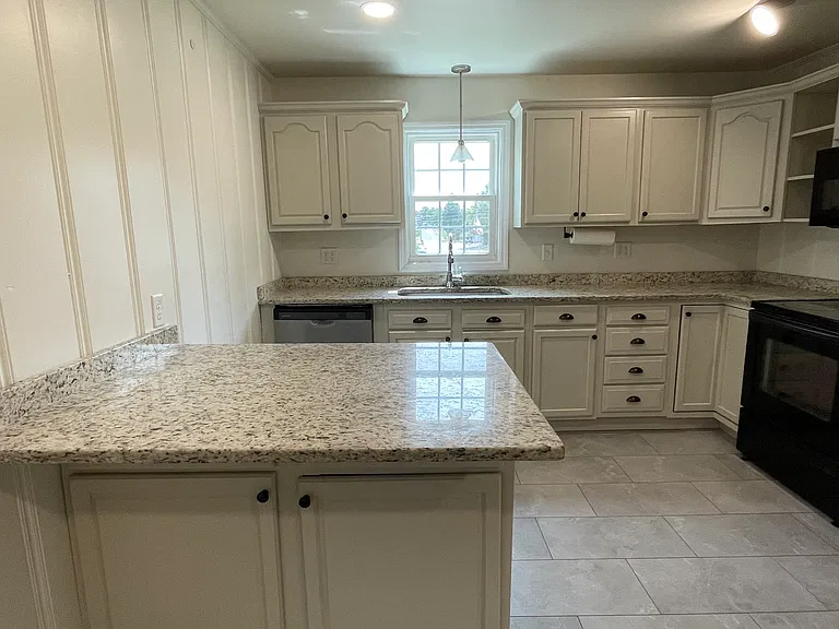Looking into kitchen from dining area.Beautiful granite countertops.