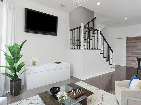 HIGH CEILINGS AND STAIRS LEADING TO MASTER SUITE ON SECOND FLOOR
