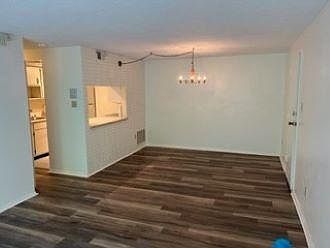 Other side of living room, hallway and kitchen to the left