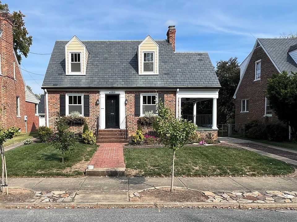 Front of the home with driveway on the right. Porch entry to home also.