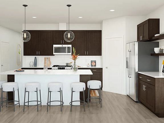 Kitchen with dark stained cabinetry floating shelves
