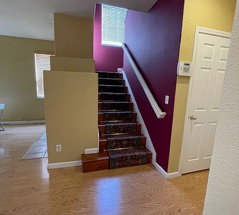 Stairs with accent walls, closet downstairs