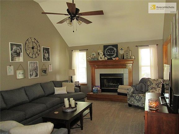 Spacious great room with new paint, lights and carpet.