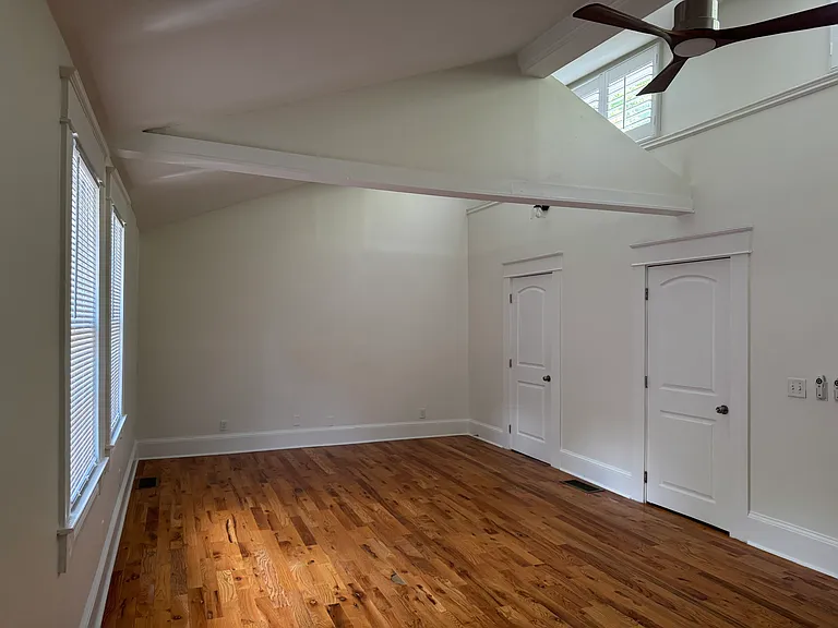 High ceilings, beautiful light in primary bedroom.